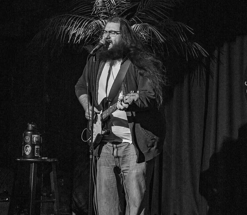 Kelsey Hudgins performing with his guitar at Sunset Strip